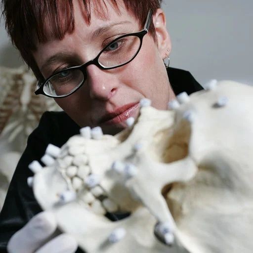 woman examining human skull